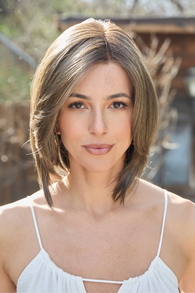 Close up of women modeling an airy and feathered wig in the color NM Truffle Brown-R by Amore.