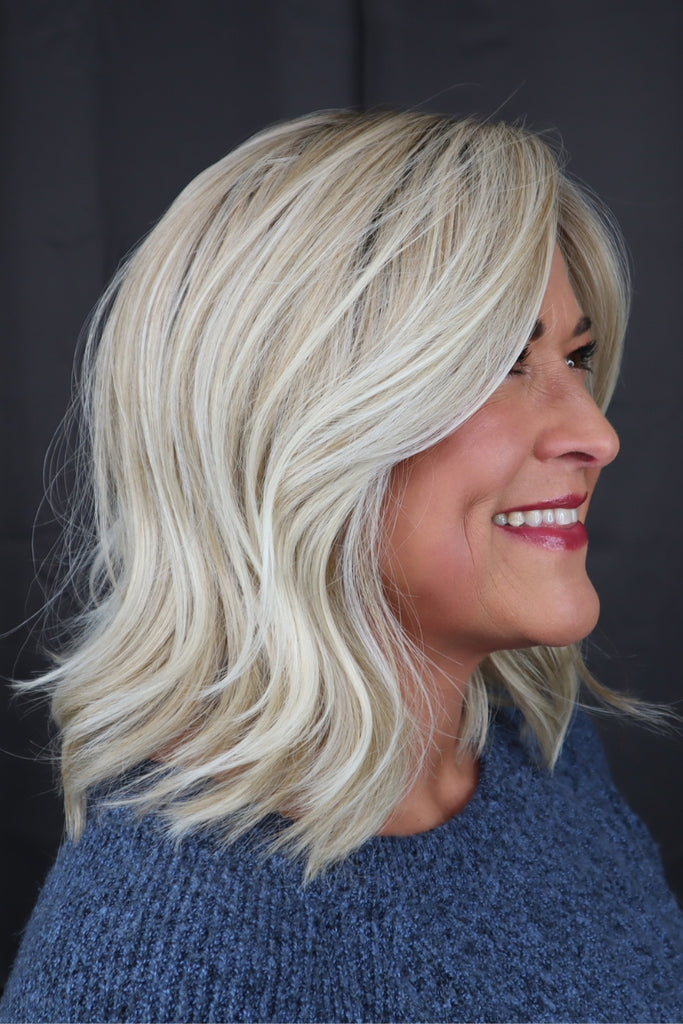 Woman wearing a shoulder length, wavy bob.