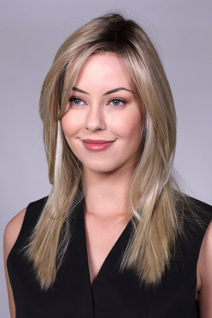 Woman wearing a long length wig with shaggy layers adding texture to the style.