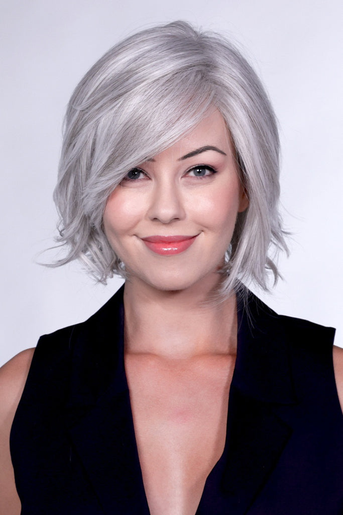 Woman wearing a medium length layered wig.