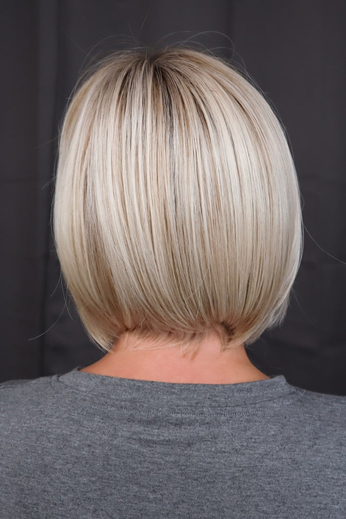 Back of model wearing a straight bob wig.