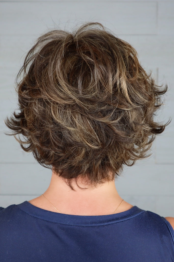 Woman wearing a short shaggy wig.