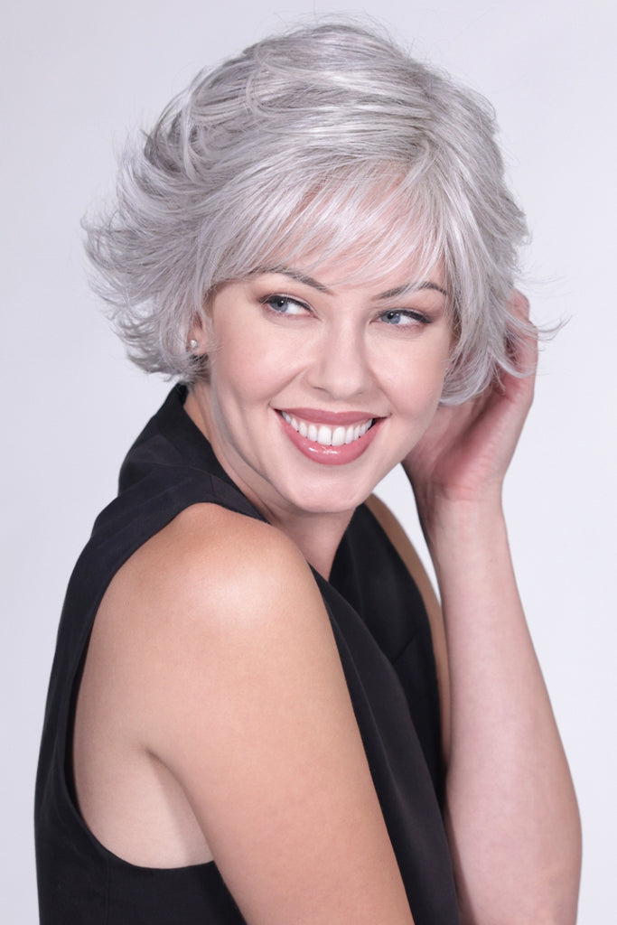 Woman wearing a light gray and pearl silver blend with a very subtle hint of light brown wig.