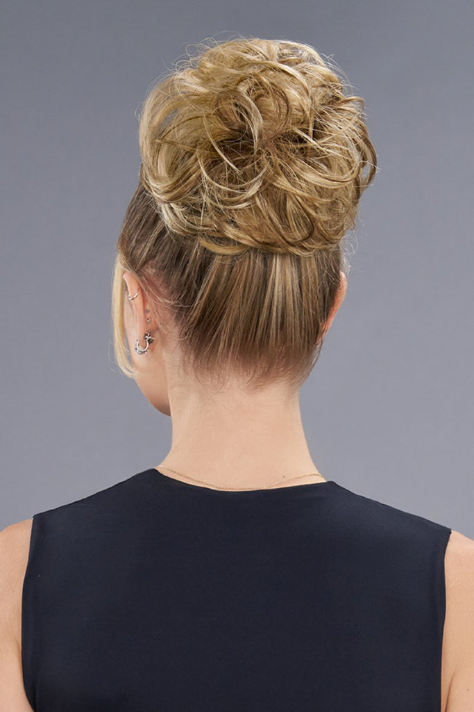 Back of model wearing a bun in the color 12F (Pecan Praline).