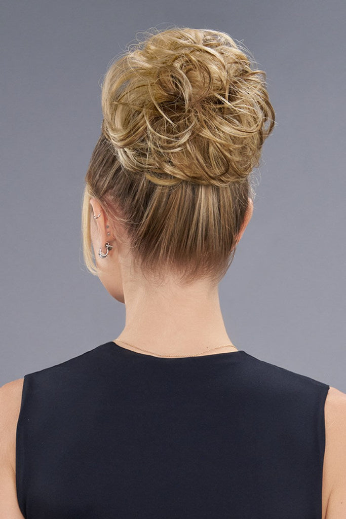 Back of model wearing a bun in the color 12F (Pecan Praline).