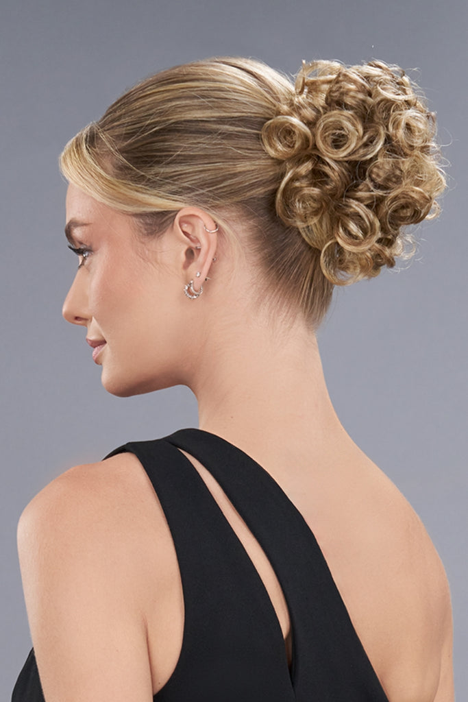 Model wearing a medium blonde color with spiral curls.