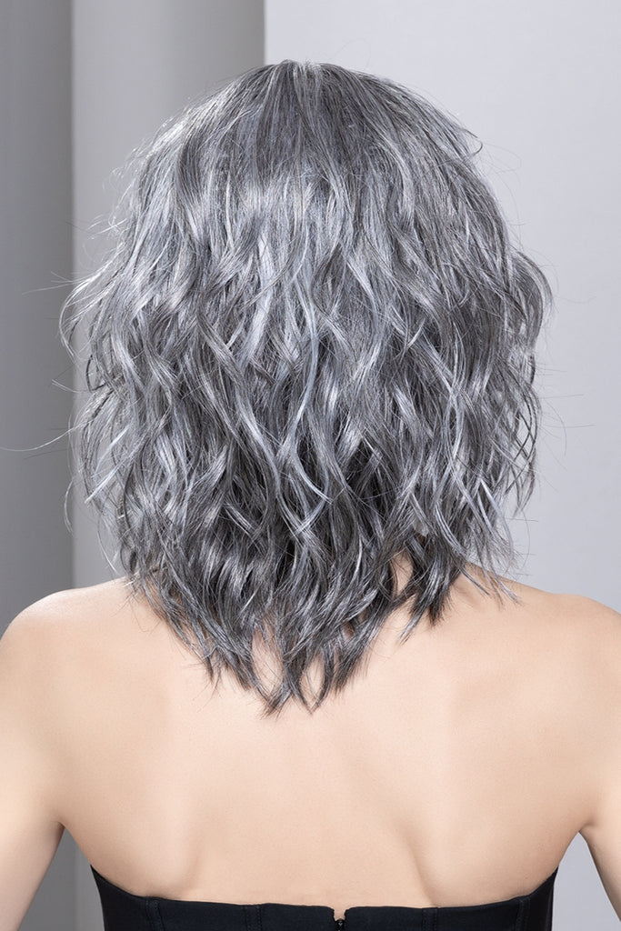 Back view of woman styling a wig in the color Dark Grey Lighted. 