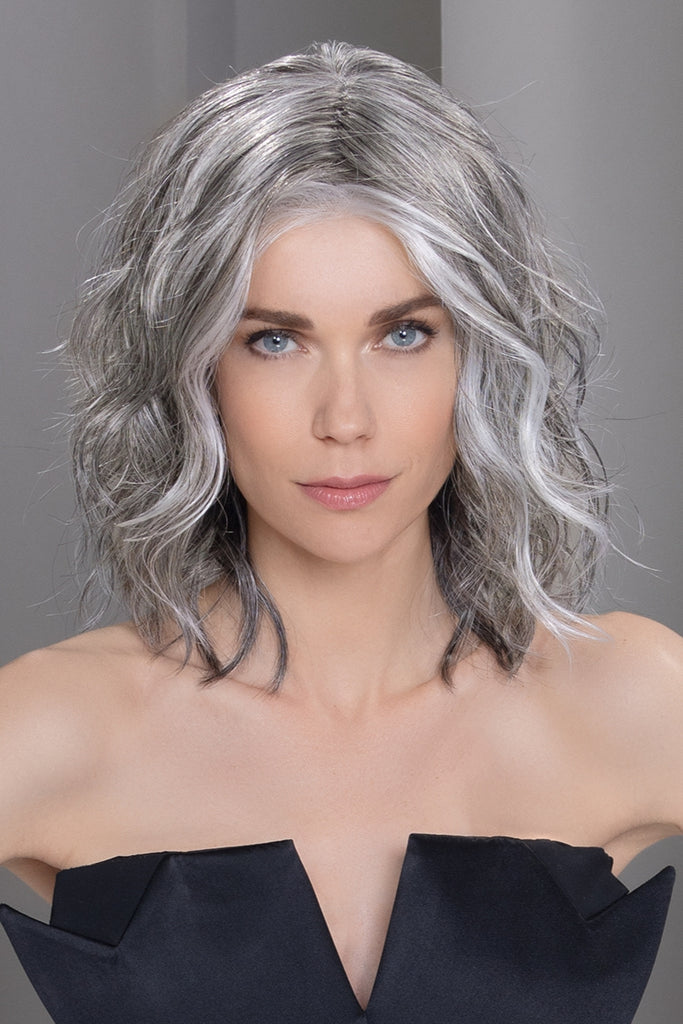 Front view of model wearing a wavy textured shoulder length wig.