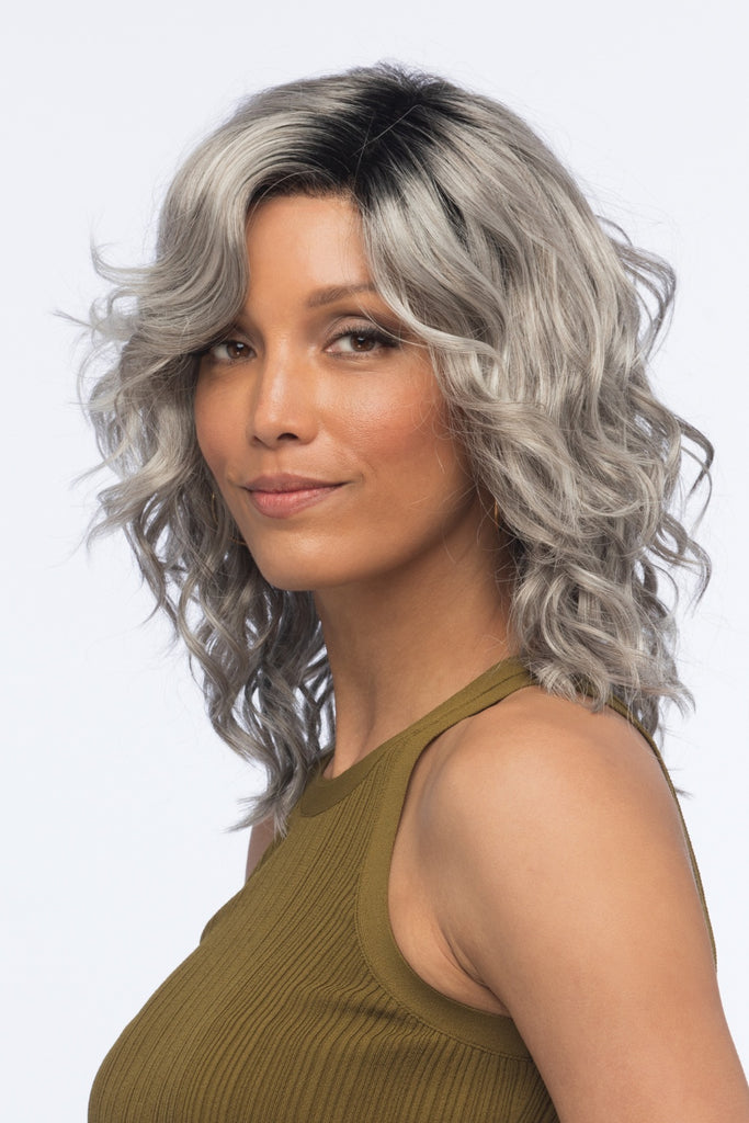 Model styling a gray and white wig with 25% Medium Brown blend & Off Black roots.