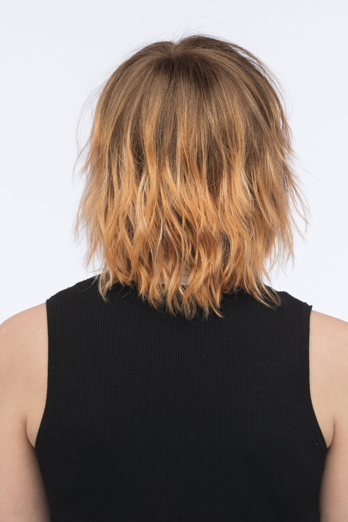 Back of model wearing a wavy wig.