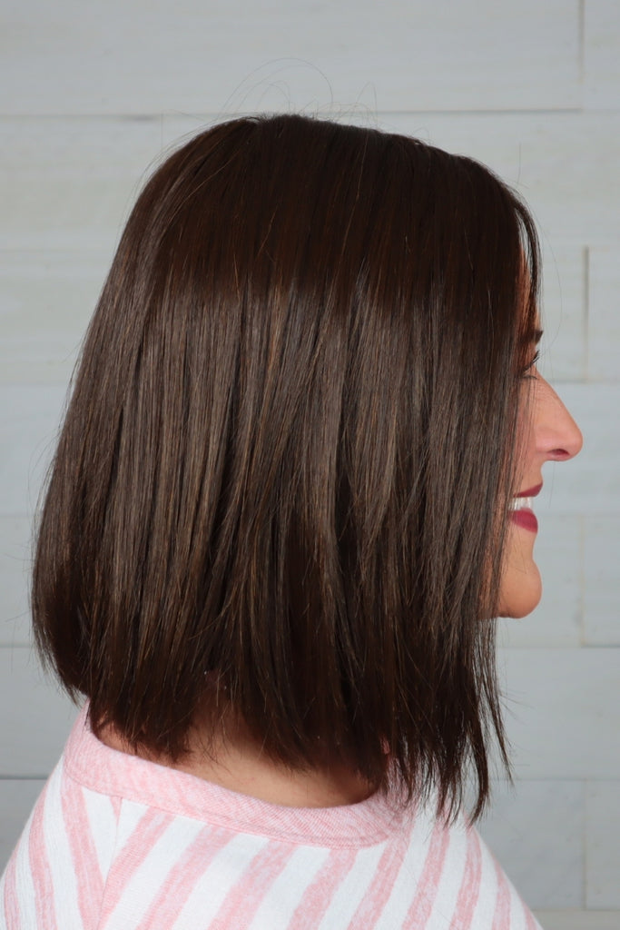 Woman wearing a sleek, shoulder length bob.