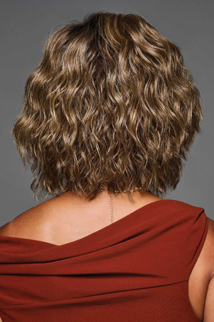 Back of women wearing a high density and high volume wig with beachy waves.