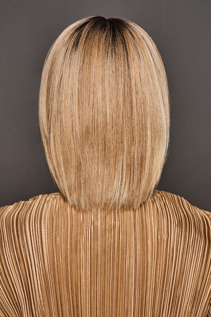 Back view of woman modeling a dark blonde, honey blonde and platinum blonde mix with dark rooting.