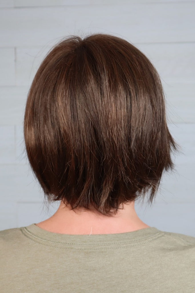 Back of model wearing a short layered bob.