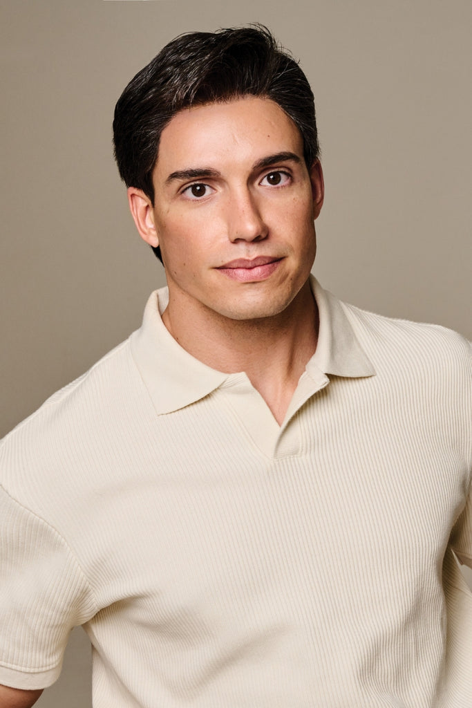 Close up of man styling a short length mens wig.