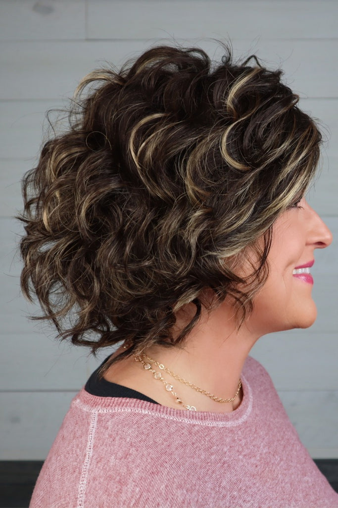 Side of model wearing a voluminous wig.