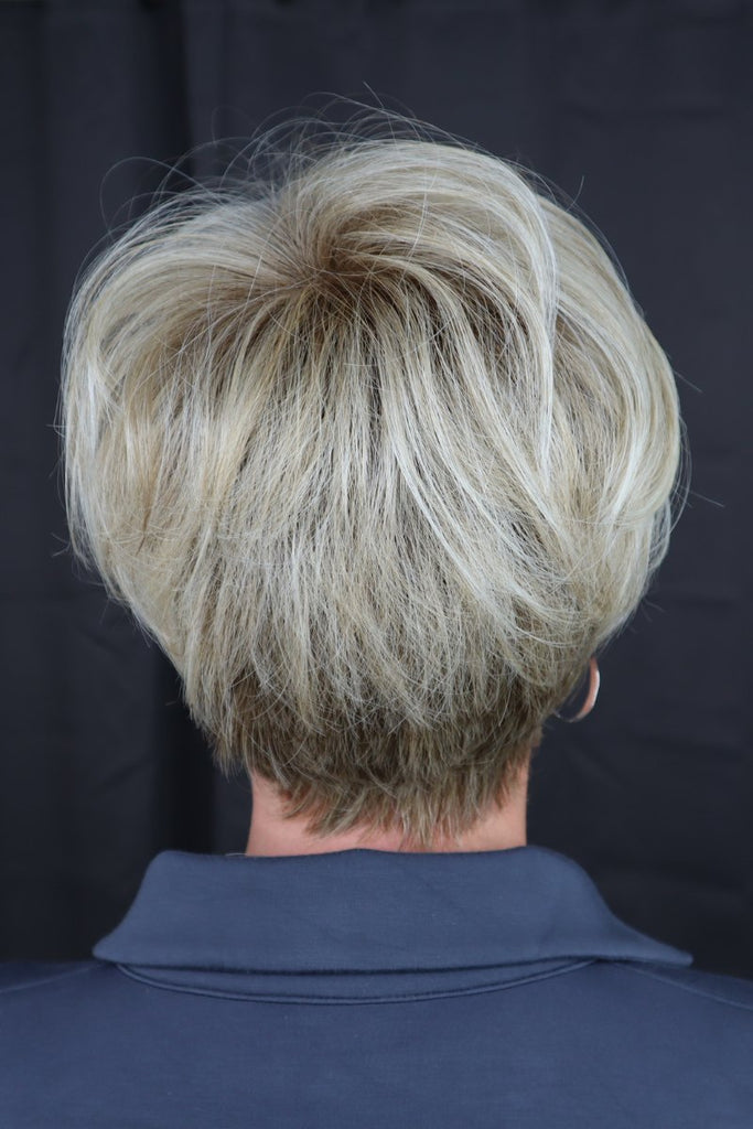 Back of woman wearing a short pixie cut wig.