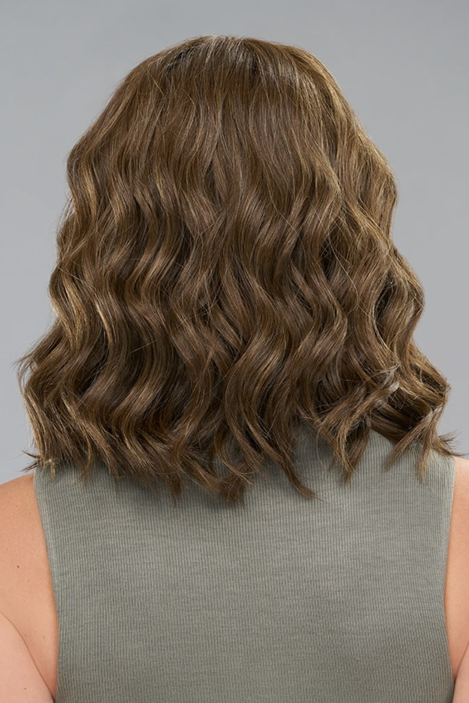 Back of model wearing a wavy mid length style.