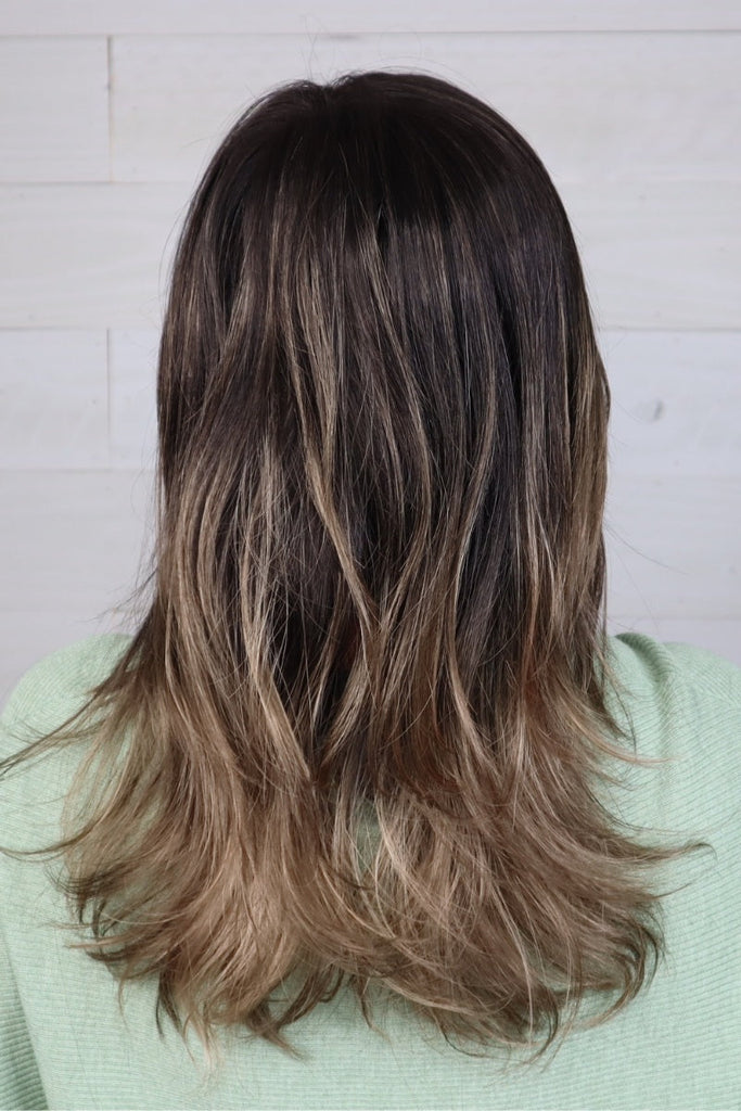 Back of model wearing a dark colored wig.