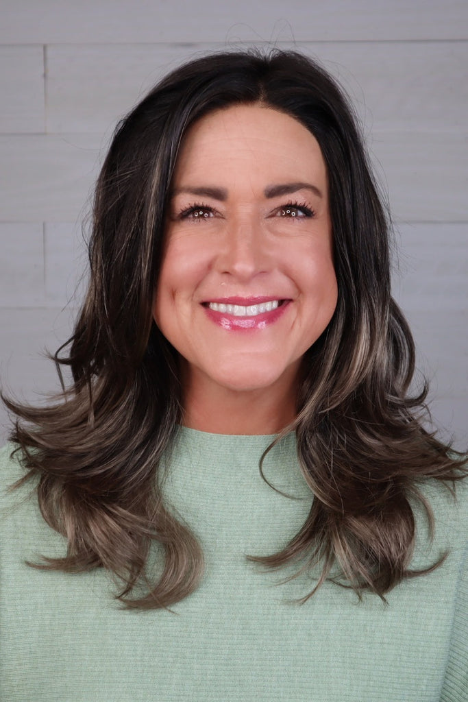 Front view of woman wearing a long flowy wig.