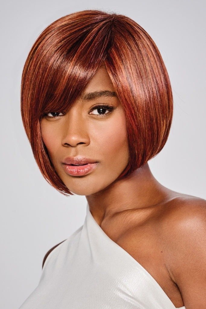 Model wearing a sleek bob wig with side swept fringe by Kim Kimble.