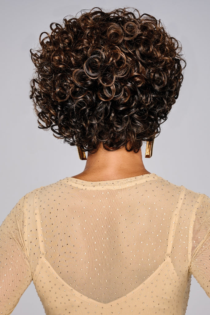 Back of model styling a fun voluminous curly wig.