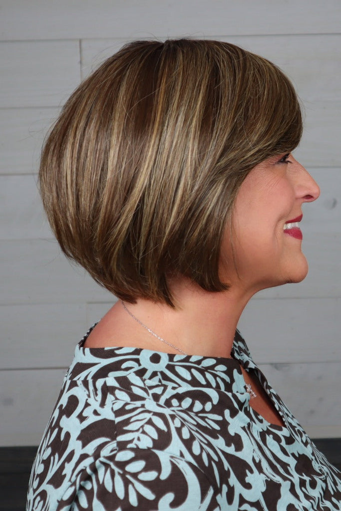 Side of model wearing a straight bob wig.