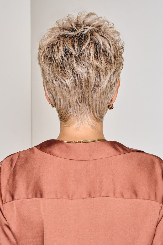 Women styling a short layered shaggy wig.