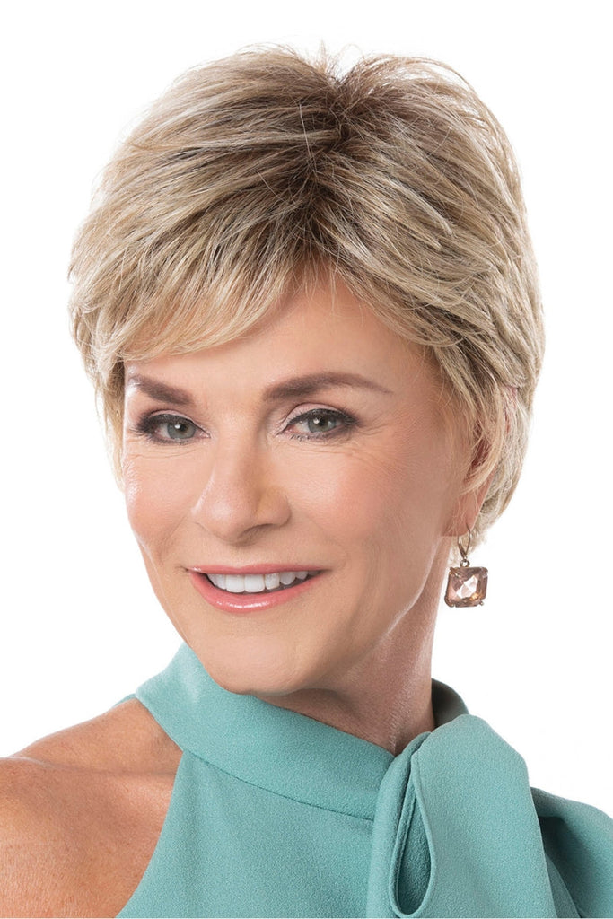 Woman wearing a short shaggy pixie cut wig with wispy bangs.